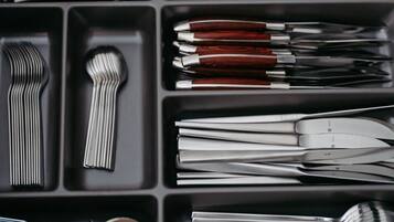 A set of kitchen utensils organized in a drawer.