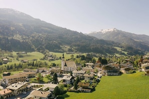 A town with a prominent church, surrounded by green fields and mountains. - Apartment in Jochberg with ski-in/out (Jochberg)
