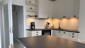 A modern kitchen with white cabinets, a dark countertop, and a coffee maker. - Berolina 313 - More sea - "More sea" in view... exclusive vacation apartment in the (Dahme)