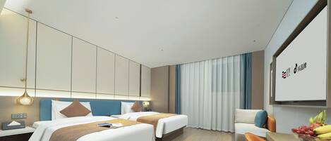 A modern hotel room with two beds, a desk, a chair, and a dining table with fruit.