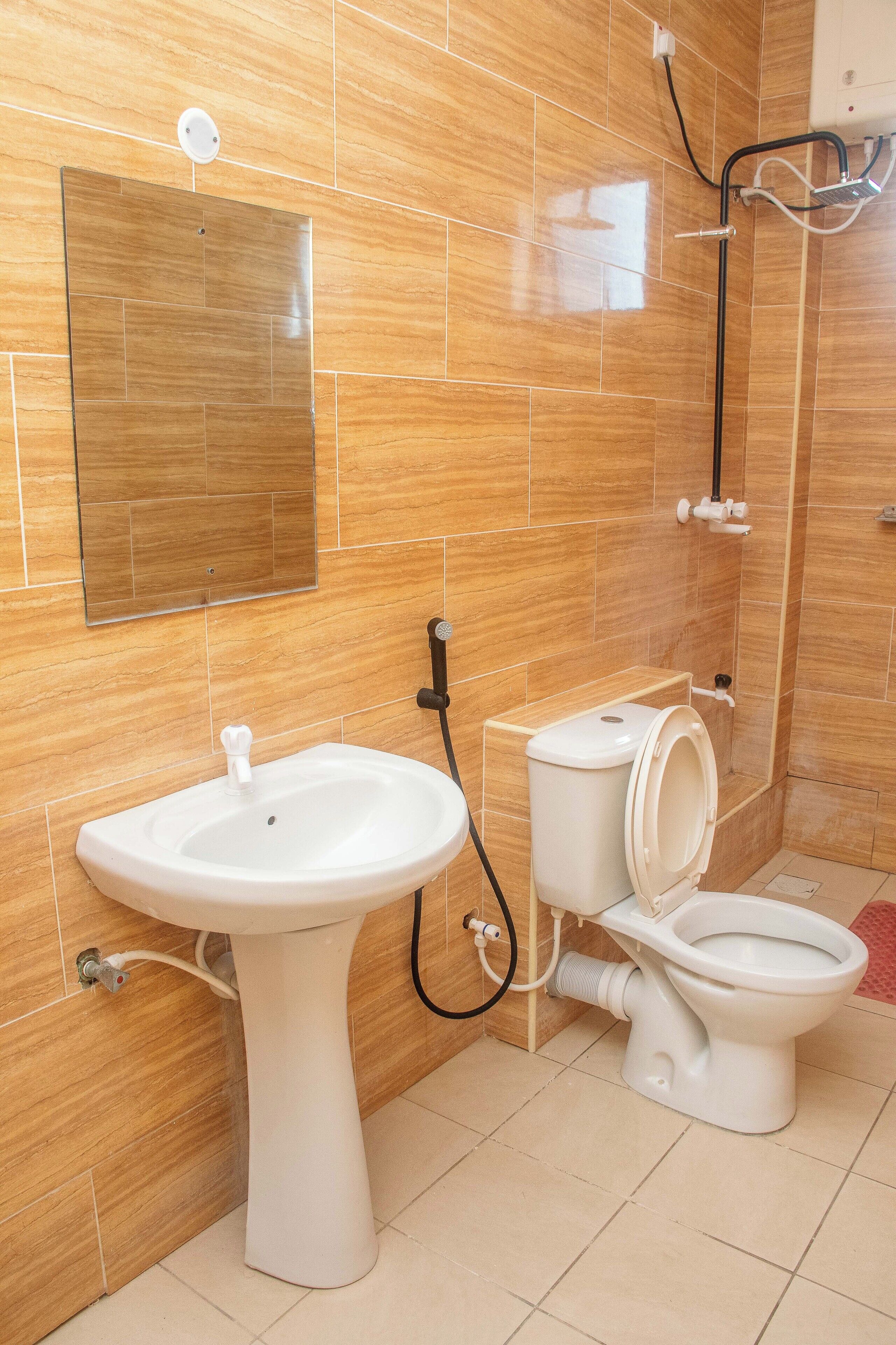 A bathroom with a sink, toilet, and shower.