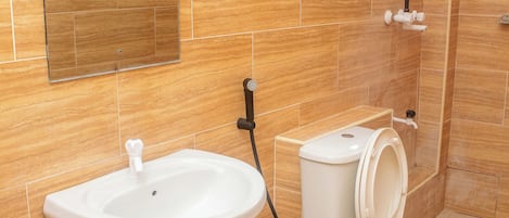 A bathroom with a sink, toilet, and shower.