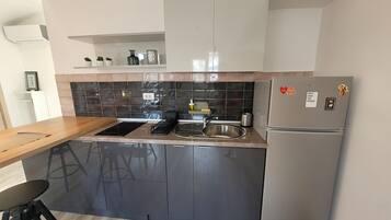 Departamento Deluxe, vista a la ciudad | Cocina privada