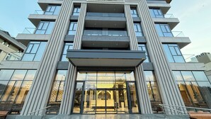 A modern building with a sign reading "XORAZM" at the top. - Khorazm Hotel (Tashkent)