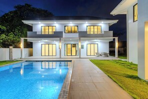 A modern two-story house with a swimming pool, large windows, and a well-maintained lawn. - 2 Villas 2 Kitchens  Huge Pool V258 (Rawai)