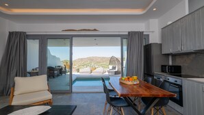 Une cuisine moderne avec vue, un coin repas donnant sur la piscine et un espace salon confortable.