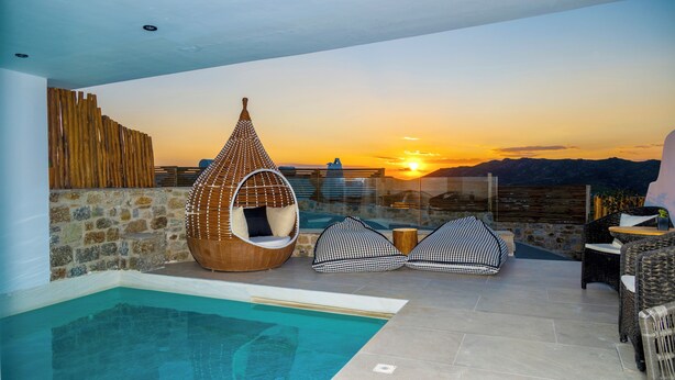 A rooftop pool area with a hanging chair, two bean bags, and a view of the sunset over mountains. - Premium 2 Bedroom House with Private Pool (Mykonos)