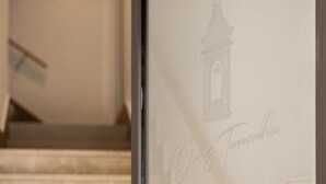 A glass door with a faint architectural drawing of a tower and the text "Chris Tompkins." - Domus Terravecchia  (Agrigento)