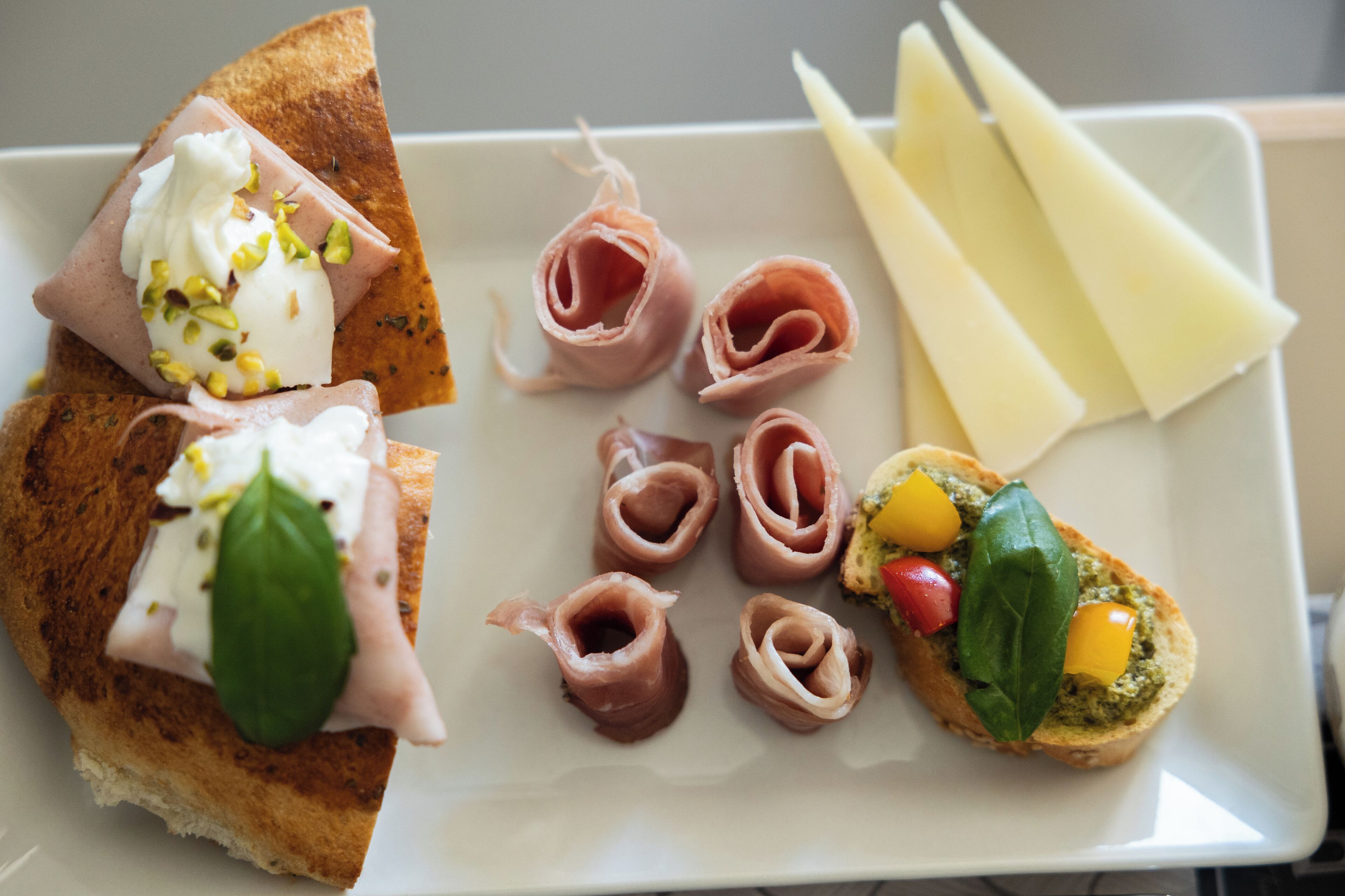 A plate with various food items including bread, cheese, and meat.