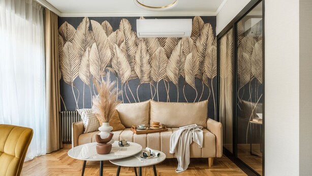 A modern living room with a sofa, two coffee tables, and a decorative wall panel. - Art Palace by Fragola Collection (Kraków)