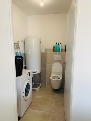 Shower, hair dryer, towels, toilet paper