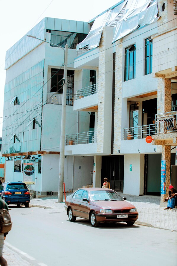 A multi-story hotel with a modern design, featuring balconies and large windows.