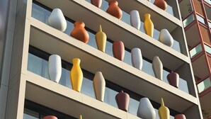 A multi-story building with balconies adorned with large, colorful vases. -  Palazzo Le Giare Luxury Apartments (Bari)
