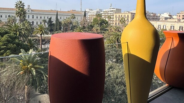 A view from a window with three large vases on a balcony. -  Palazzo Le Giare Luxury Apartments (Bari)