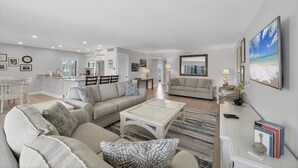 A spacious living area with a sofa set, a coffee table, and a dining area with chairs. - Charming 2 Bedroom Sea Oats - 237 in Boca Grande, perfect for a relaxing getaway. (Boca Grande)