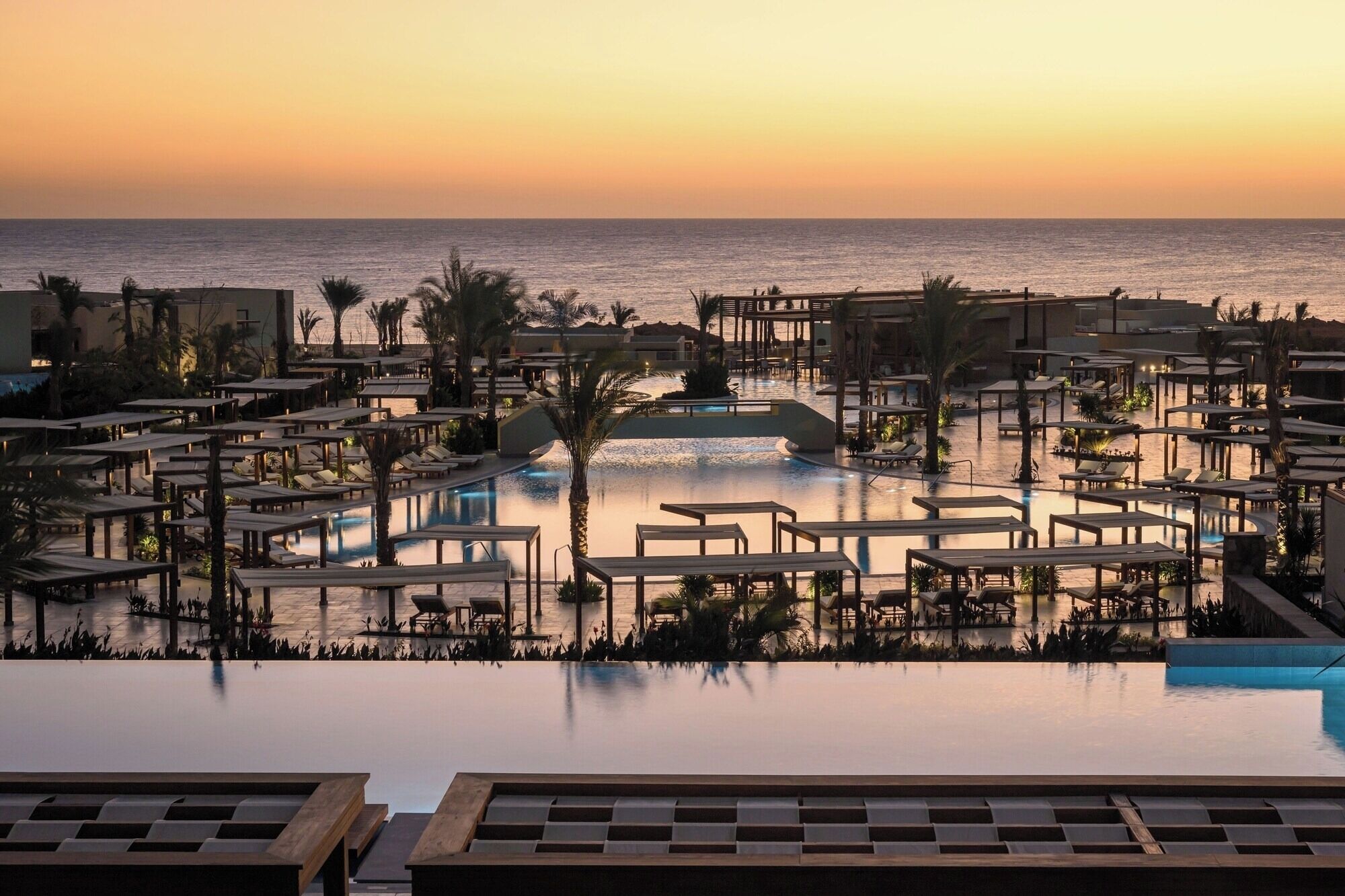 Soak in golden sunsets over pools with endless sea views.