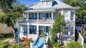 A two-story house with a balcony, a flag, and a sign for 'The Inn.' - Crystal Room | Team Joseph Ellen (St. Augustine)