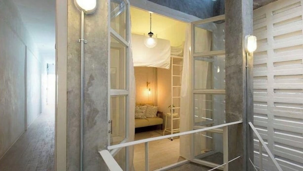A room with a bed, a ladder, and a hanging light fixture. - TWH Hostel Bangkok (Bangkok)