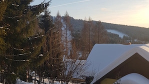 A snowy landscape with a house and a forest in the background. - Albrechtice Laq016 in Albrechtice v Jizersk ch hor ch (Albrechtice v Jizerských horách)