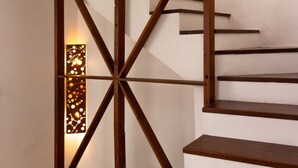 A staircase with wooden railings and a wall-mounted light fixture.