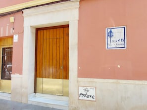 A building with a wooden door and a sign indicating 'Casa No 15.'