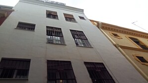 A multi-story building with large windows and a flat facade. - Duplex with Private Terrace in Seville Center (Sevilla)