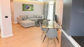 Deluxe Apartment | Living area | 50-cm Smart TV with satellite channels