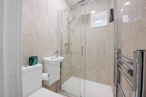 Shower, hair dryer, towels, shampoo