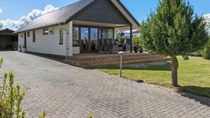 A single-story house with a covered porch and a paved driveway. - 5 Star Holiday Home in Bogense (Bogense)