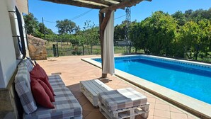 An outdoor pool area with lounge chairs and a pergola. - Holiday Home 'Huerta del Sol' with Private Pool, Balcony, and Air Conditioning (Aracena)