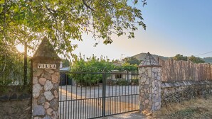 A stone gate with 'VILLA' and 'SOTINA' signs, leading to a paved area with a fence and trees. - Holiday Home 'Huerta del Sol' with Private Pool, Balcony, and Air Conditioning (Aracena)