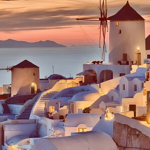 A coastal hotel with white architecture, a lighthouse, and a view of the sea. - Studio Apartment 'Pleasure View 2 Persons 3' with Mountain View, Wi-Fi and Air Conditioning (Perissa)