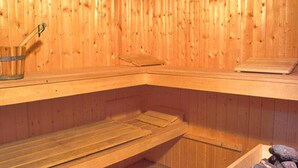 A sauna with wooden walls and benches. - Holiday Home in Ebensee Near Mountain Railway (Ebensee)