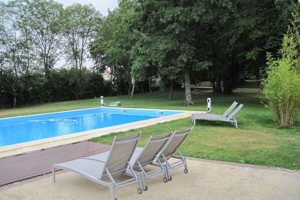 A swimming pool with three lounge chairs and a brick patio. - Very Spacious and Luxurious Holiday Home on Quiet Estate With Pool (Buzon)