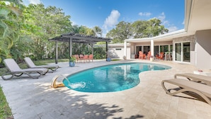 A swimming pool with lounge chairs, a covered seating area, and a patio with outdoor furniture. - Relax in the Sun! Gem 1 Mi to Las Olas Beach (Fort Lauderdale)