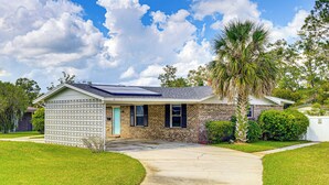 A single-story house with a brick exterior, a small porch, and a solar panel on the roof. - Waterfront JAX Townhome w/ River Access! (Jacksonville)