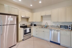 A modern kitchen with light-colored cabinets, stainless steel appliances, and a granite countertop. - Golf, Hike & Boat! Bright Lake Havasu City Apt (Lake Havasu City)