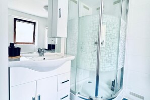 Shower, hair dryer, towels, soap