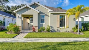A single-story house with a front entrance, a small porch, and a well-maintained lawn.