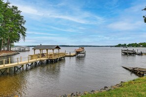 A lakeside dock with a gazebo, a covered area, and a small boat. - 'sunset Central' - Lake Norman Getaway With Dock (Mooresville)