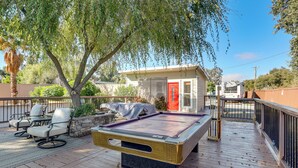 A pool table on an outdoor deck with chairs, a covered barbecue, and a building with a red door in the background. - Solo Escape w/ Hot Tub! 10 Mi to Dtwn Sacramento (Rio Linda)