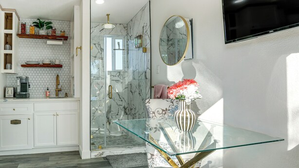 A modern bathroom with a glass shower enclosure, a marble backsplash, and a vanity with a mirror. - Solo Escape w/ Hot Tub! 10 Mi to Dtwn Sacramento (Rio Linda)
