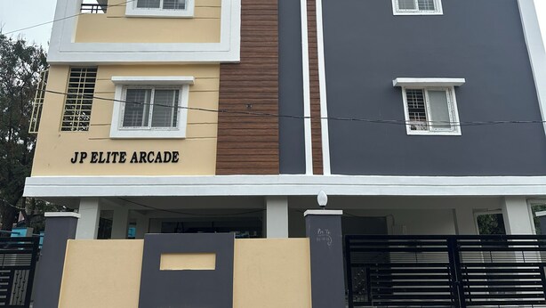 A multi-story building with a sign reading "JP ELITE ARCADE". - CC Elite Homestay (Hyderabad)