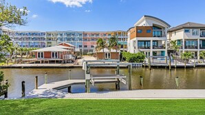 A waterfront hotel with multiple buildings, a dock, and a canal. - 171 Canal Cove: 2br W/ Canal Views 2 Bedroom Home (Fort Myers Beach)