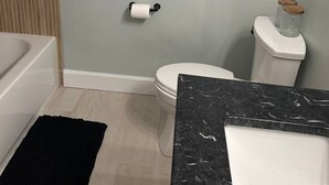 A bathroom with a toilet, a sink, and a bathtub.