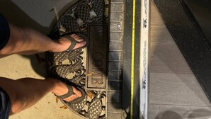 A person measuring a door with a ruler.