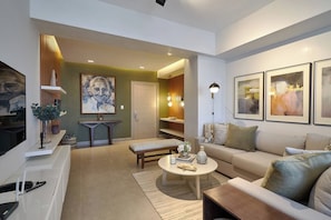 A modern living room with a sofa, coffee table, and artwork on the walls.