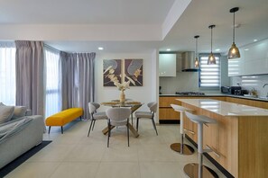 A modern apartment with a dining area, kitchen, and living space. - ®2BR{The~City~Center}@DTown +Pool+Gym NearCecilip (Santo Domingo)
