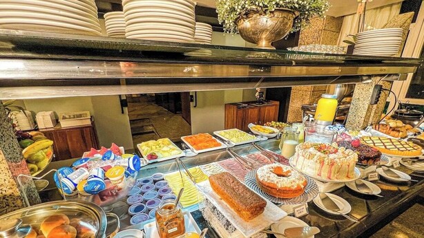 A buffet with various food items and utensils.