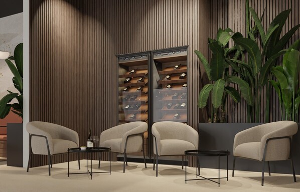 A modern lounge area with seating, a wine rack, and large plants. - Hotel Siscia (Sisak)